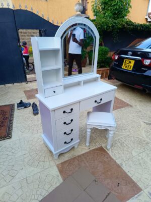 Modern dressing table with lighted mirror in a stylish bedroom setup