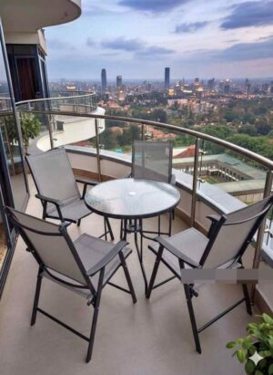 Ultimate Luxury Balcony Bistro Set with Mesh Chairs and Glass Table Overlooking City Skyline at Dusk Luxurious 4-piece balcony bistro set with round glass table and black mesh chairs on high-rise balcony with stunning city view