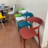 Plastic Cafe Chairs – Durable Outdoor and Indoor Seating Modern stackable plastic cafe chairs arranged on a sunny outdoor patio